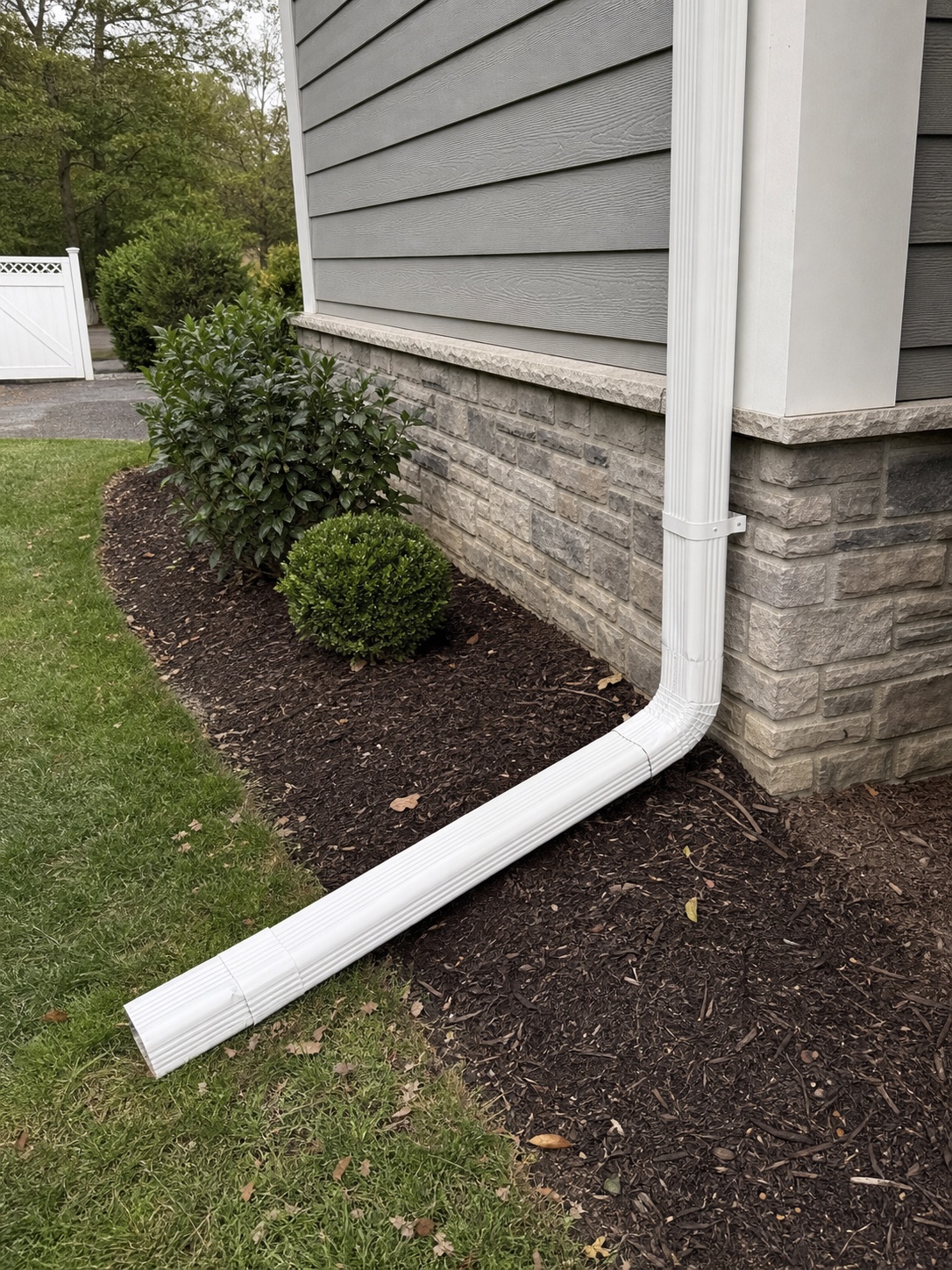 Downspout with extension directing water away from a home